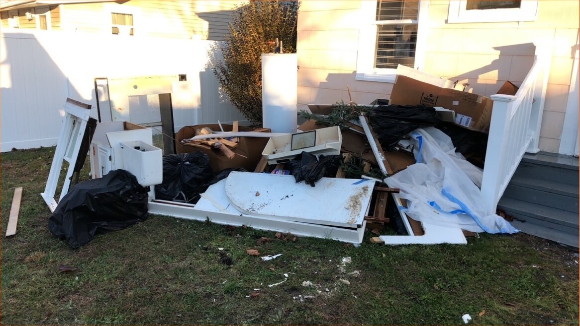 Appliances and white goods pulled out of a property and stacked ready for collection