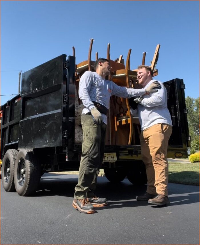 The ExtraHands ASAP crew laughing after loading furniture onto the trailer