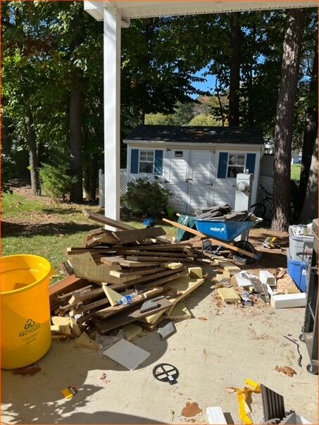 Renovation debris and lumber cleared from a driveway