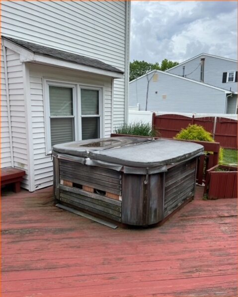 A hot tub on a rear deck, ready to be broken down and hauled away